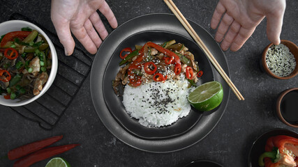 Chicken teriyaki on rice and vegetables, Japanese food on black background