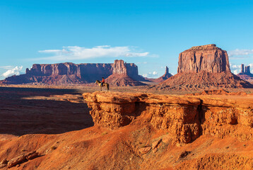 John Ford's viewpoint in Monument Valley Navajo Tribal Park with a unrecognizable Navajo Horseman staging the scene of the movie Stagecoach, Arizona, USA.