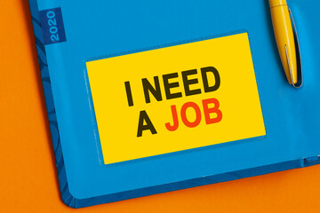 I NEED A JOB the word is written in black letters on the yellow paper for notes.