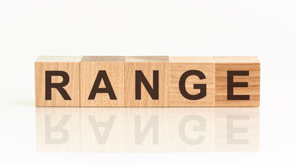 Wooden Blocks with the text: range. The text is written in black letters and is reflected in the mirror surface of the table.