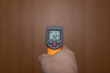 Holding a thermometer
