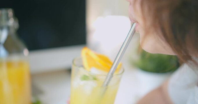young woman drinking Juicy fresh orange juice with straw, healthy lifestyle refreshment summer concept