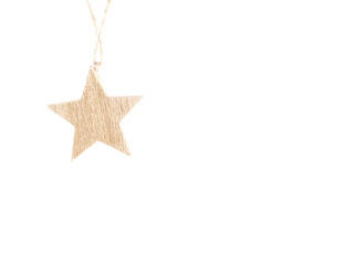 Wooden star christmas decoration hanging on white background