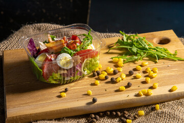 bacon egg salad on the board in container