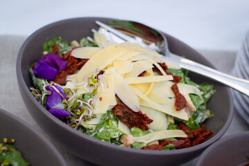 Green Caesar salad with sundried tomatoes. Healthy catering service buffet table at a summer party.