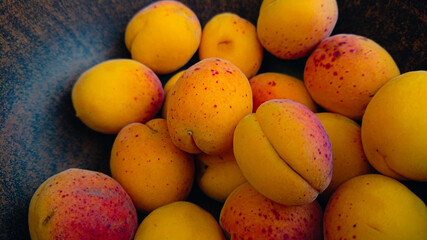 Many apricots in a deep clay plate