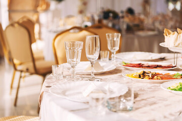 Table setting at a banquet, beautiful dishes, glasses