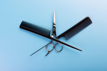 Professional tools for hairdresser on blue background