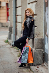 Woman in shopping. Happy woman with shopping bags enjoying shopping. Autumn vibes. 