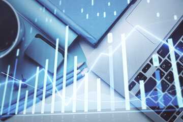 Double exposure of forex graph drawing over desktop background with computer. Concept of financial analysis. Top view.