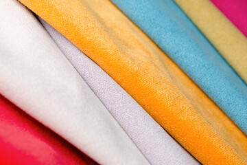 Bright collection of colorful velour textile samples. Fabric texture.