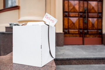 Contactless food delivery service concept. Paper bag with groceries ordered online delivered