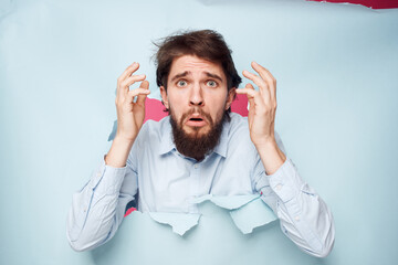 emotional man in blue shirt breaks through wall emotions cropped view office