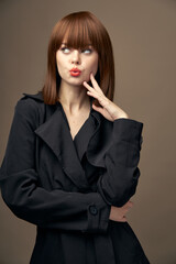 Sensual lady European appearance coat beige background