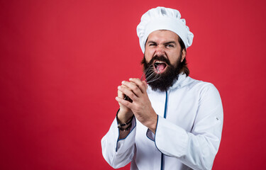 handsome man with beard and moustache singing with beater, having fun, copy space