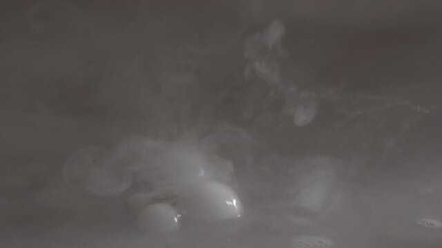 Smoke gas bubbles made with dry ice pop in the air, visual texture eff