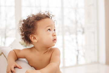 Cute baby with fluffy hair. Pretty boy.