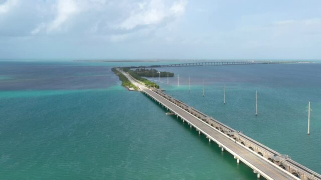 Aerial morning view of cars passing over the US1 seven mile long bridge over the sea towards the Miami Keys Florida