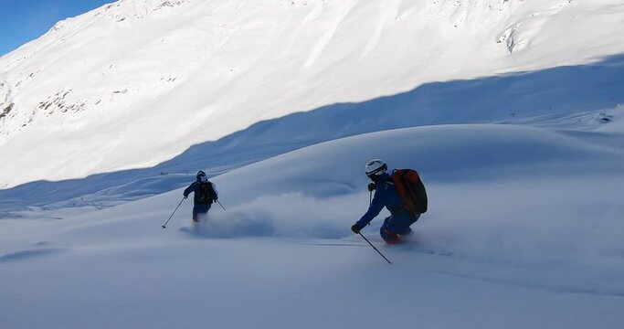Two Professional skier skiing deep snow. Freeride skiing in Ischgl. Offpist with fresh snow on ski's. Ischgl Tirol Austria