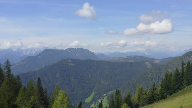 Layers of mountains and peaks covered with green forest. Peca Alps.