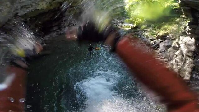Man going down a slide in the Peira canyon, a spectacular canyon located in the French Alps.