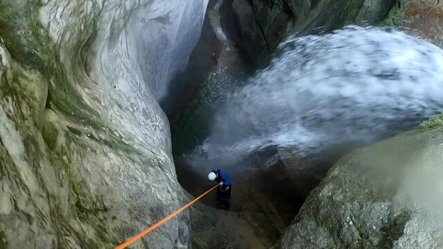Man rappelling down the Monar canyon, a spectacular canyon located in the French Alps.