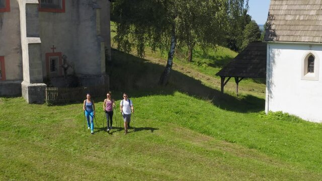 A drone shot of three hikers arrived at a monastery at Lese, Slovenia.