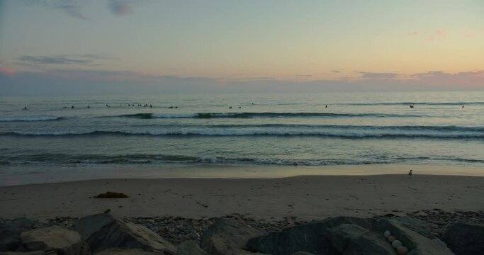 Beautiful Sunset over Californian Beach with Wetsuit hanging in FG