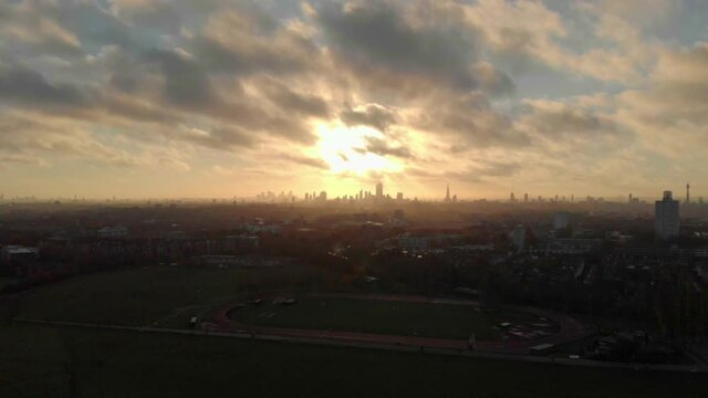 falling drone shot of beautiful sunrise over London skyline