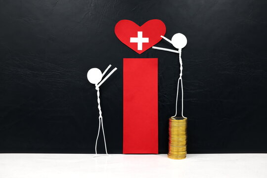 Stick man figure reaching for a red heart shape with cross cutout while stepping on stack of coins. Health, healthcare, medical care and hospital access inequality concept.