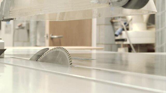 Mid shot of  Industrial saw changing the angle of cut to 45 degrees.