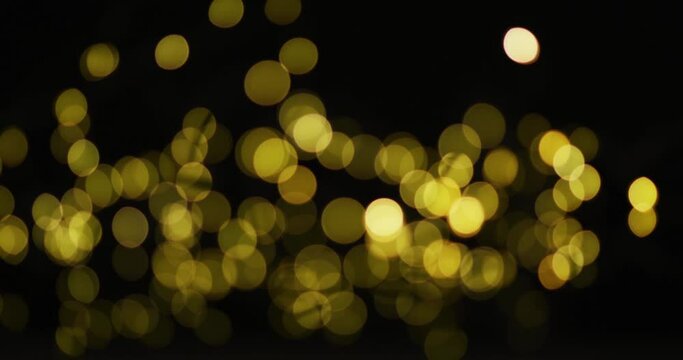 Multiple yellow fairy lights glowing on black background