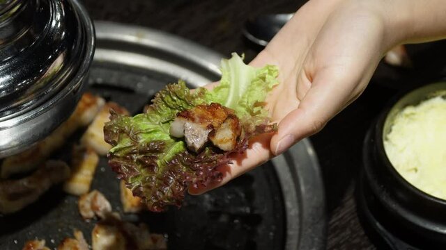 Delicious Korean barbecue wrapped in a lettuce leaf -close up