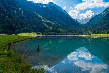 Durlassboden reservoir in the Zillertal Alsp, mountain lake with reflection in austria