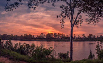 Beautiful Riverside Sunset Panorama with Cloud Reflections