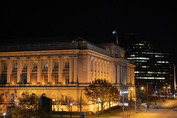 Cleveland downtown city buildings at night with golden / orange illumination. 