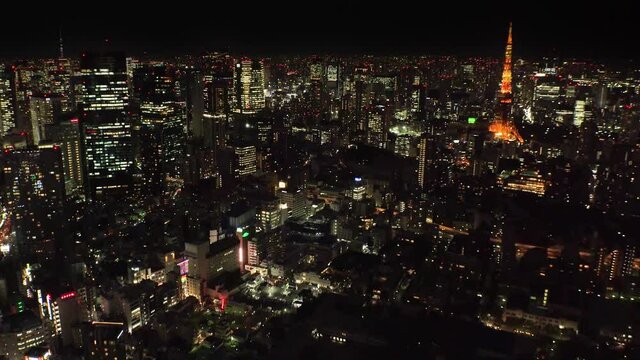 TOKYO, JAPAN : Aerial high angle sunrise CITYSCAPE of TOKYO. View of central downtown area around Roppongi. Japanese urban metropolis concept shot. Long time lapse shot night to morning. Tracking shot