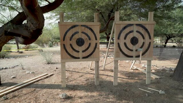 Slow motion Axe Throw at Target at Manly Tribal Event for Competition
