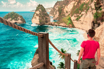 Active lifestyle people travel in Bali and explore amazing Bali attraction. Diamond Beach &ndash; Most Beautiful Beach on Nusa Penida in Bali. Indonesia.