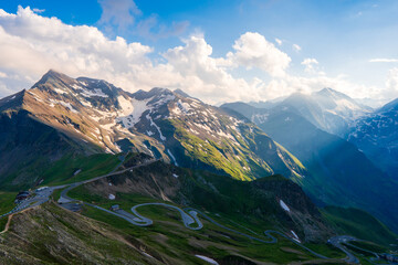 Fototapeta na wymiar Panoramic Image of Grossglockner Alpine Road. Curvy Winding Road in Alps. Dramatic Sky. Austria