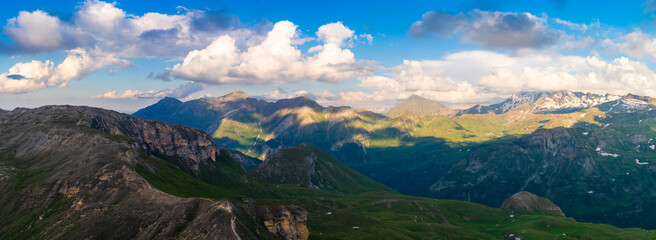 Fototapeta na wymiar Panoramic Image of Grossglockner Alpine Road. Curvy Winding Road in Alps. Dramatic Sky. Austria