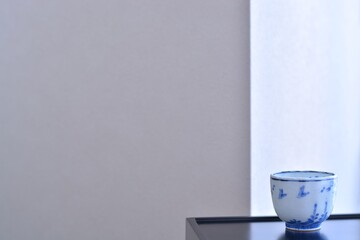 picture cup. put on a Japanese lacquer shelf. This is a very fine example of Japanese traditional antique “ imari ware ”. blurred background soft focus image.