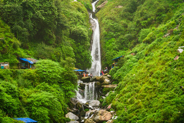 Majestic landscape of Bhagsu Nag waterfall and green forest around at Mcleodganj, Himachal Pradesh, India. - obrazy, fototapety, plakaty