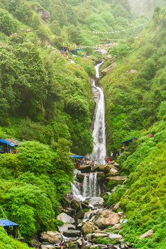 Majestic landscape of Bhagsu Nag waterfall and green forest around at Mcleodganj, Himachal Pradesh, India.