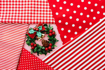 Fototapeta premium Christmas composition. Christmas red decorations, fir tree branches on red background. Flat lay, top view, copy space