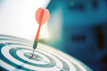 bullseye target or dart board has red dart arrow throw hitting the center of a shooting for...