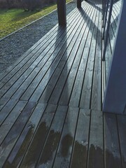 The sun is shining from the other side of the wooden deck