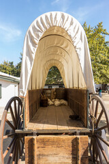 Inside view of a covered wagon with wood bed and canvas top