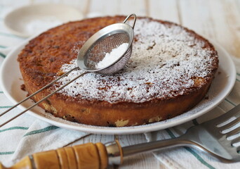 The process of making semolina pie with ingredients on a wooden background. Sprinkle cake with icing sugar. Food background.