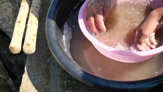 The fishermen wash and filter group of fresh Krill or Opossum shrimp with clean water, Plankton that fishermen trap for cooking in Thailand